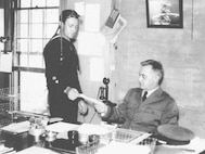CDR Stone at his desk as the commanding officer of Air Station Cape May, circa 1933.  
U.S. Coast Guard Photo No. G-APA-10-15-73 (17).