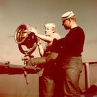 Uniform: Dungarees 
The Coast Guard signalman operating the blinker lamp is SM 3/c Theodore Cholewinski, USCGR, WWII
Coast Guard Archives
