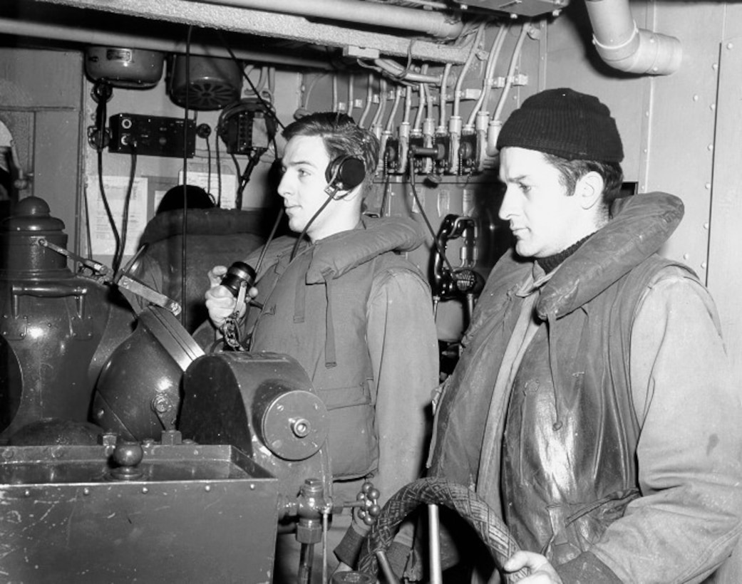 Helmsman and talker on the bridge of a cutter at sea in the North Atlantic, WWII