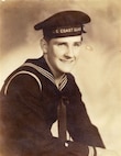 Coast Guardsman Marvin Perret, USCGR, in dress blues: this uniform was the same as worn by Navy sailors except for the shield device, in white, on the lower right sleeve which denoted Coast Guard personnel and the cap ribbon which had "U.S. Coast Guard" stitched on it instead of "U.S. Navy", WWII.


