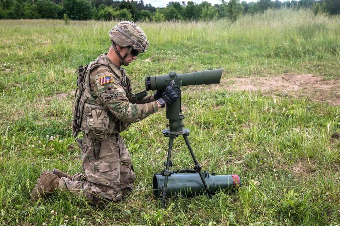 A soldier uses a range designator before emplacing an M777A2 Howitzer as part of exercise Saber Strike 2017, at Bemowo Piskie Training Area near Orzysz, Poland, June 7, 2017. Army photo by Spc. Stefan English