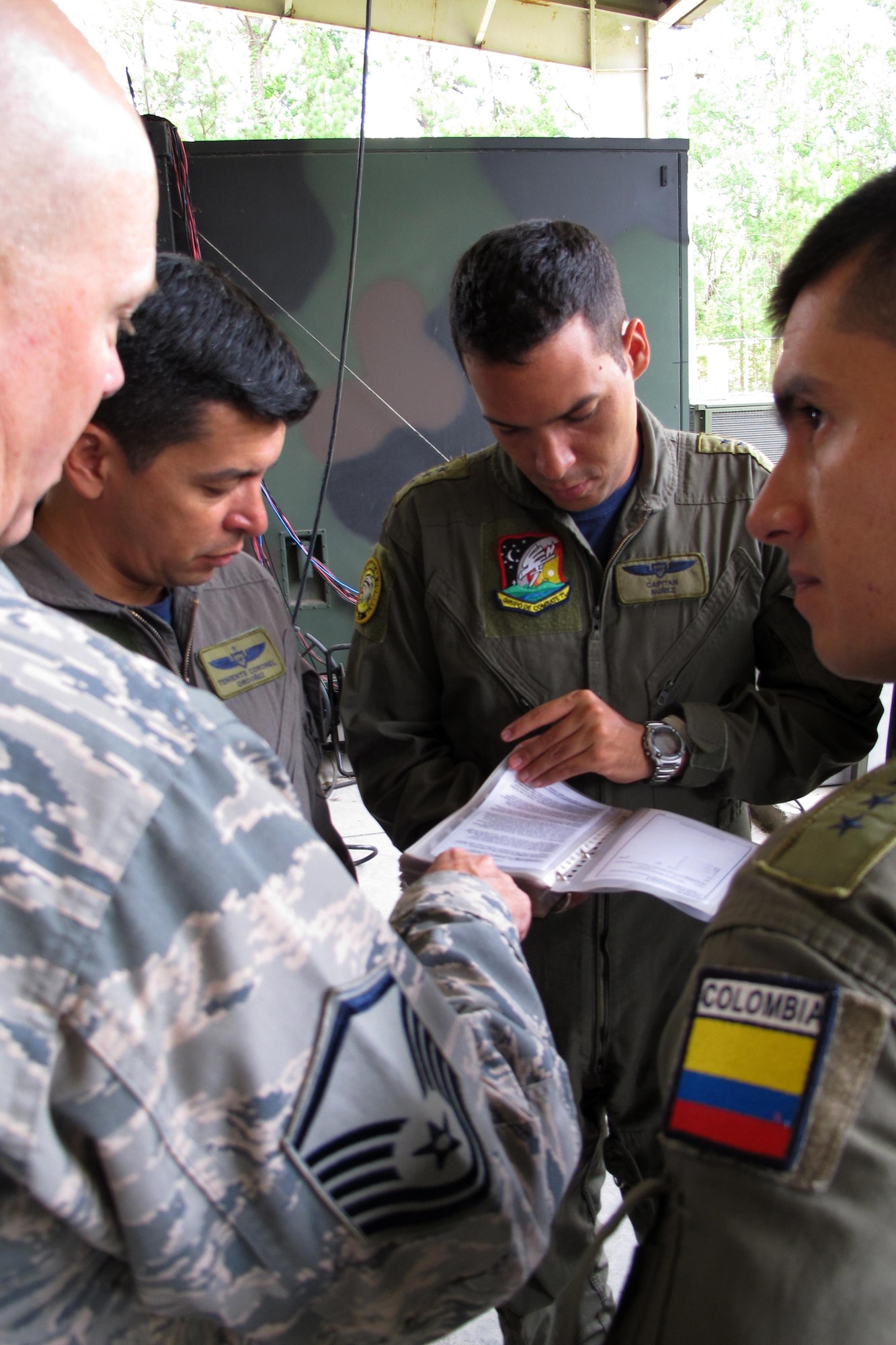 Members of the Colombian Air Force discuss training plans for U.S. Air Force Controllers during a visit with the Georgia Air National Guard’s 117th Air Control Squadron at Hunter Army Airfield in Savannah, Georgia during a State Partnership Program Subject Matter Expert Exchange on Ground Control Intercept, May 30-June 2, 2017. During the weeklong engagement the Colombians worked with Air Controllers from 117th shaping Colombian Air Force training plans by pairing experts together to exchange ideas. The Georgia Air National Guard supported the South Carolina National Guard’s State Partnership Program during the engagement.    (U.S. Air National Guard photo by Capt. Stephen D. Hudson)