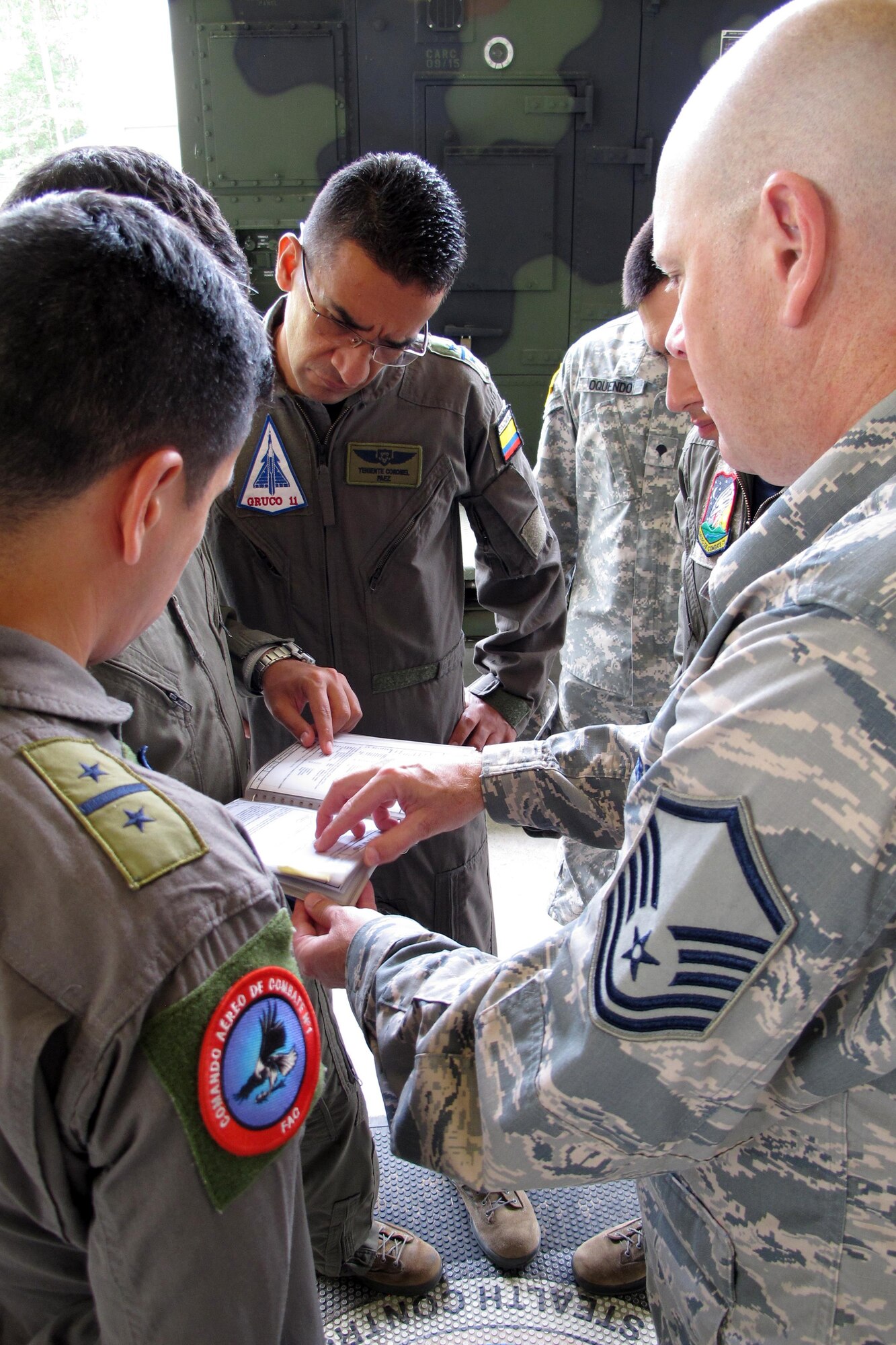 Members of the Colombian Air Force discuss training plans for U.S. Air Force Controllers during a visit with the Georgia Air National Guard’s 117th Air Control Squadron at Hunter Army Airfield in Savannah, Georgia during a State Partnership Program Subject Matter Expert Exchange on Ground Control Intercept, May 30-June 2, 2017. During the weeklong engagement the Colombians worked with Air Controllers from 117th shaping Colombian Air Force training plans by pairing experts together to exchange ideas. The Georgia Air National Guard supported the South Carolina National Guard’s State Partnership Program during the engagement. (U.S. Air National Guard photo by Capt. Stephen D. Hudson)