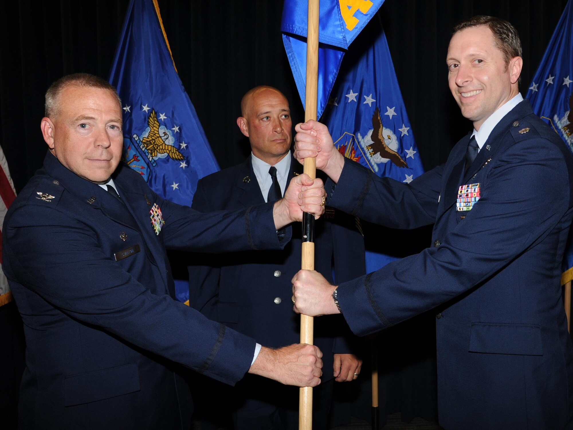 Col. Robert Stanton, 302nd Operations Group commander, left, passes the 731st Airlift Squadron guidon to Lt. Col. Robert Fairbanks as he assumes command of the 731st AS during a change of command ceremony at Peterson Air Force base, Colo., June 4, 2017. Fairbanks is a traditional Air Force reservist and command pilot with more than 7,100 military flying hours and over 10 years supporting the Modular Airborne Fire Fighting System mission. “The priorities I set as a commander are to aviate, navigate and communicate,” said Fairbanks during his first address to the Reserve Citizen Airmen he now leads. “We have to fly the airplane first, successfully navigate our lives, and communicate with each other to build trust.” (U.S. Air Force photo/Staff Sgt. Amber Sorsek)