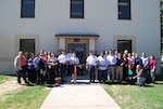 Air Force Col. Alice W. Treviño, Defense Contract Management Agency Western Region commander, is joined by DCMA Albuquerque employees as she cuts the ribbon to officially open building 20200B, DCMA Albuquerque’s new Kirtland Air Force Base office facility. From left: Denise Ulibarri, Brittney Volk, Craig Jones, Lisa Solis, Sean Anderson, Wade McVey, Mary Trimbell, Kelly Smith, Jon Gonzales, Stephanie Vigil, David Romero, Debora Santillan, Army Col. Robert Miceli, Vicki Strause, George Allen, Joe Hernandez, Treviño, Army Lt. Col. John Pires, Victor Guevara, Samantha King, Fabian Melendez, Travis Lincoln, Bobby Moore, Max Martin, Octavio Zamarron, Craig Ammons, Kerena Dominguez, Troy Norcross, Mary Cunningham, Diane Albert-Graham, Mike Dicker, Cheryl Zahn, Robert Jackson, Walt Schaffer and Cristelle Gagne. (DCMA photo by Pearl Delgado, DCMA Albuquerque) 