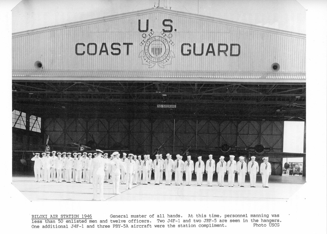 Air Station Biloxi, Mississippi
An official Coast Guard photo scanned from an article written by Colonel Ted Morris entitled "A Short History of Operations at U.S. Coast Guard Air Station Biloxi, Mississippi; December 1934-March 1947".  The photo's caption reads: "Biloxi Air Station, 1946: General muster of all hands.  At this time, personnel manning was less than 50 enlisted and twelve officers.  Two J4F-1 and two JRF-5 are seen in the hangar.  One additional J4F-1 and three PBY-5A aircraft were the station complement."