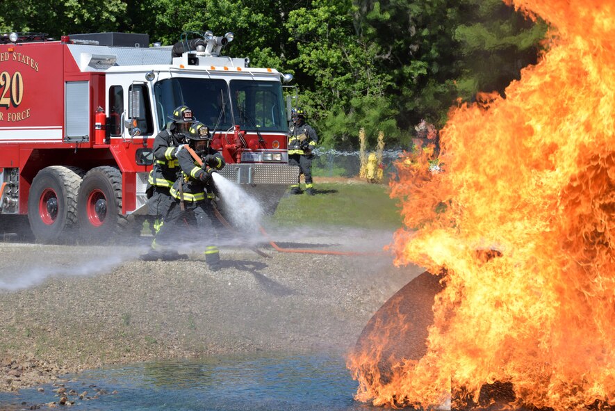 Firefighters, Jeff Turner (front) and Rick Breitenstein, from the 788th Civil Engineer Squadron extinguish an aircraft fire as part of annual proficiency skill training for firefighters, at their training burn pit, May 30, 2017, at Wright-Patterson Air Force Base, Ohio.  The crew demonstrated their ability to work as a team to attack and extinguish two and three-dimensional fires, example—simulated fuel fire, pooling, spilling, running from the engines and on the ground. (U.S. Air Force photo/Michelle Gigante)