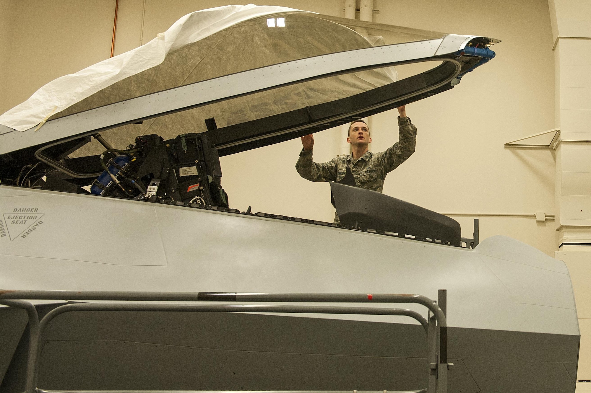 U.S. Air Force Tech. Sgt. Jeremy Finley, F-22 Raptor crew chief instructor at the 372nd Training Squadron, Detachment 14, prepares the canopy of an F-22 Raptor simulator at Joint Base Elmendorf-Richardson, Alaska, June 7, 2017.  Det. 14 is part of the Air Education and Training Command's 82nd Training Wing out of Sheppard Air Force base in Wichita Falls, Texas. 