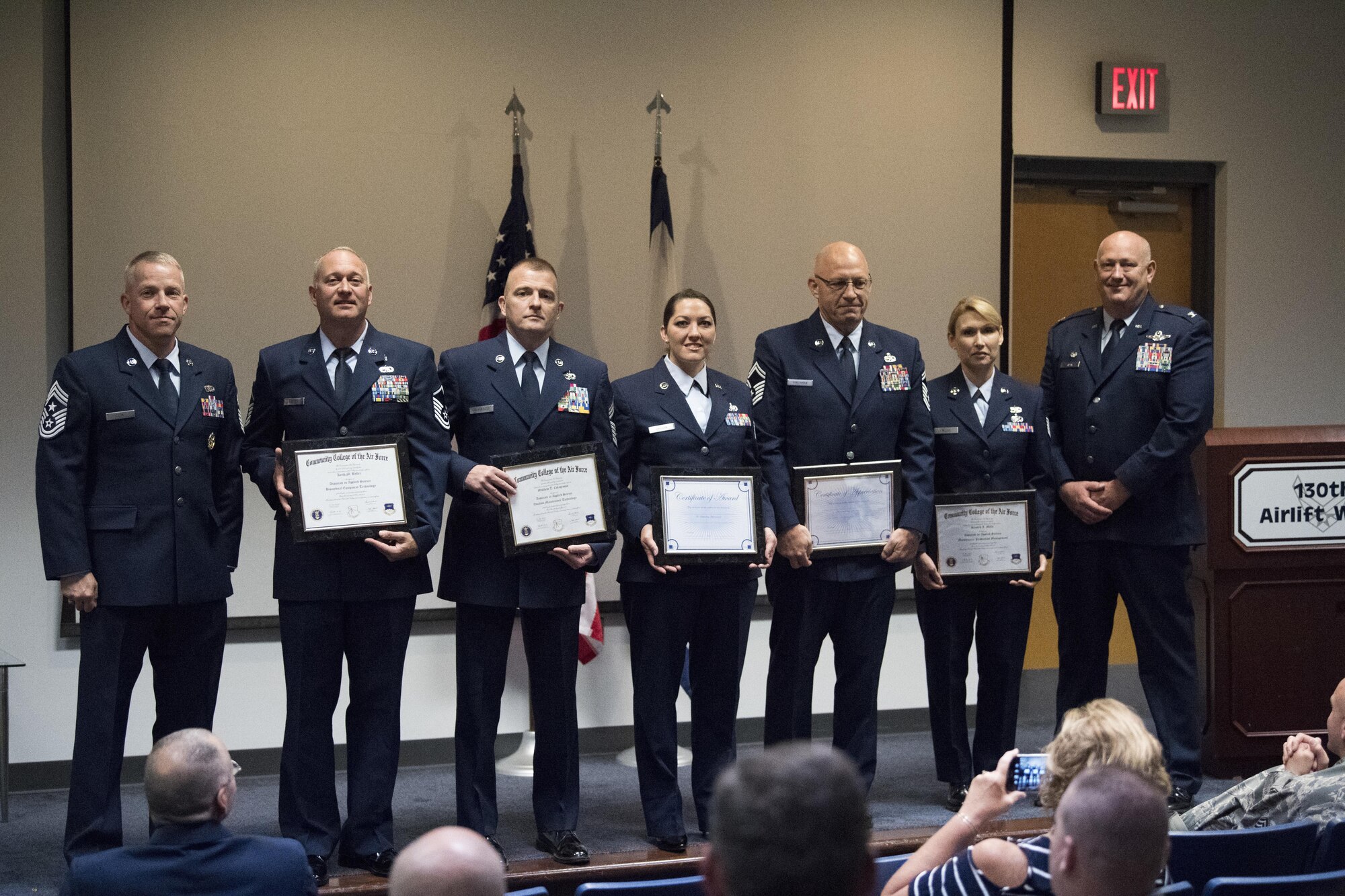 Graduates from the Community College of the Air Force pose for a photo with 130th Airlift Wing commander Col. Johnny Ryan (far right) and Command Chief Master Sgt. Kevin Cecil (far left) June 4, 2017 following a graduation recognition ceremony held at McLaughlin Air National Guard Base, Charleston, W.Va. Five members of the 130th AW recently completed their CCAF degrees and were lauded for their accomplishments at the graduation recognition ceremony. (U.S. Air National Guard photo by Capt. Holli Nelson)