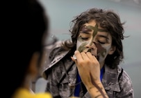 Parker Trujillo gets his face painted during the Operation Heroes event at Minot Air Force Base, N.D., June 3, 2017. Operation Heroes is an annual event that gives kids the experience of what their parents go through when they deploy. (U.S. Air Force Photo by Staff Sgt. Chad Trujillo)