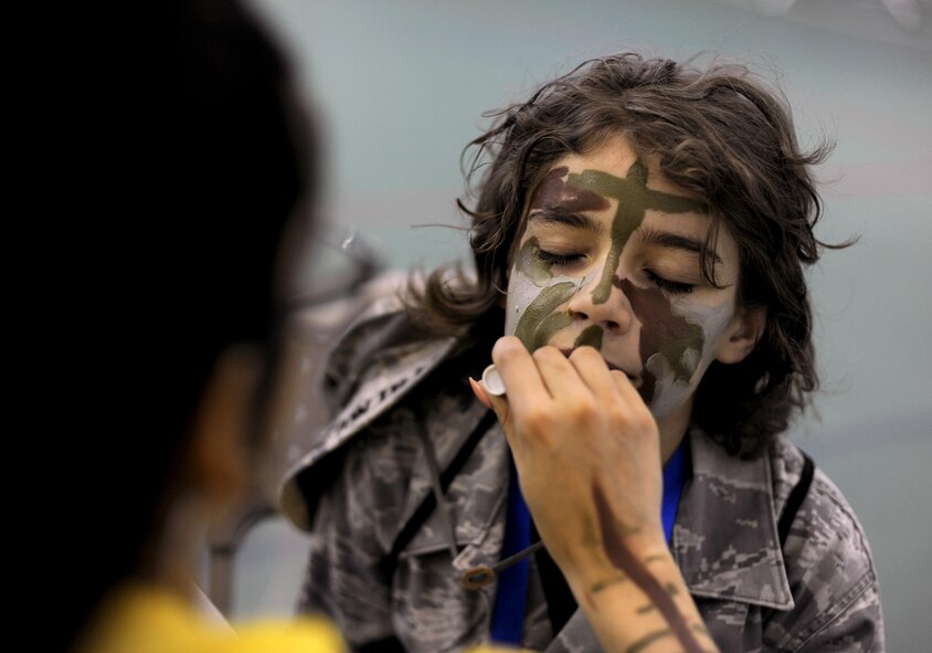 Parker Trujillo gets his face painted during the Operation Heroes event at Minot Air Force Base, N.D., June 3, 2017. Operation Heroes is an annual event that gives kids the experience of what their parents go through when they deploy. (U.S. Air Force Photo by Staff Sgt. Chad Trujillo)