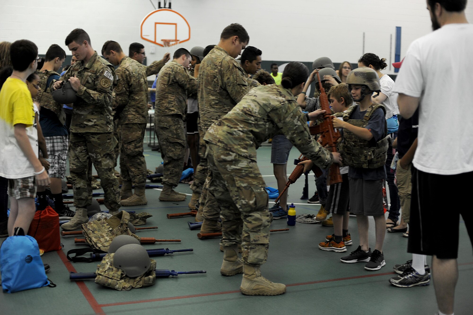 Members from the 791st Missile Security Forces Squadron convoy response force help children gear up at Operation Heroes at Minot Air Force Base, N.D., June 3, 2017. Operation Heroes is an annual event that also included gear to try on, different weapons displays and a deployment line. (U.S. Air Force Photo by Staff Sgt. Chad Trujillo)