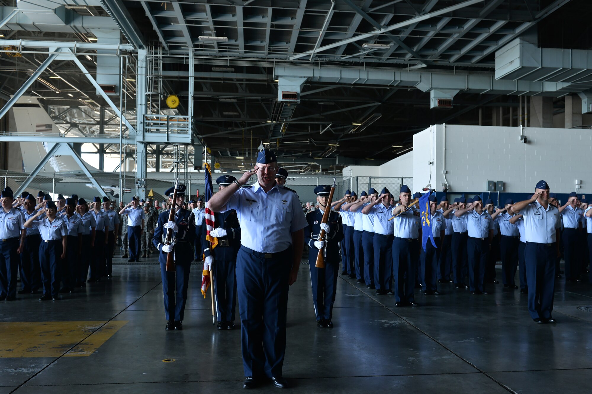 Col. David Berg, 55th Wing vice commander, leads a formation during the 55th Wing change of command ceremony in Dock 1 of the Bennie Davis Maintenance Facility on Offutt Air Force Base, Neb., June 8. The Fightin' Fifty-Fifth said farewell to Col. Marty Reynolds and welcomed Col. Michael Manion.