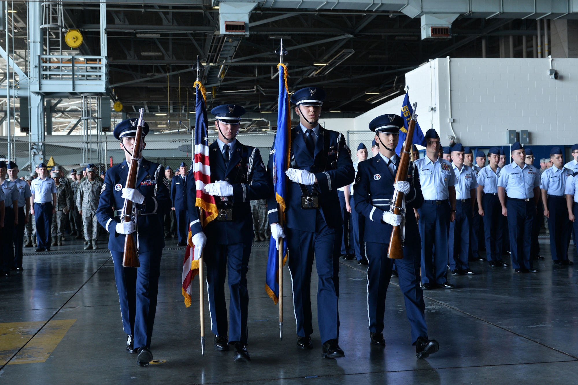 The Honor Guard presents the colors during the 55th Wing change of command ceremony in Dock 1 of the Bennie Davis Maintenance Facility on Offutt Air Force Base, Neb., June 8. The Fightin' Fifty-Fifth said farewell to Col. Marty Reynolds and welcomed Col. Michael Manion.