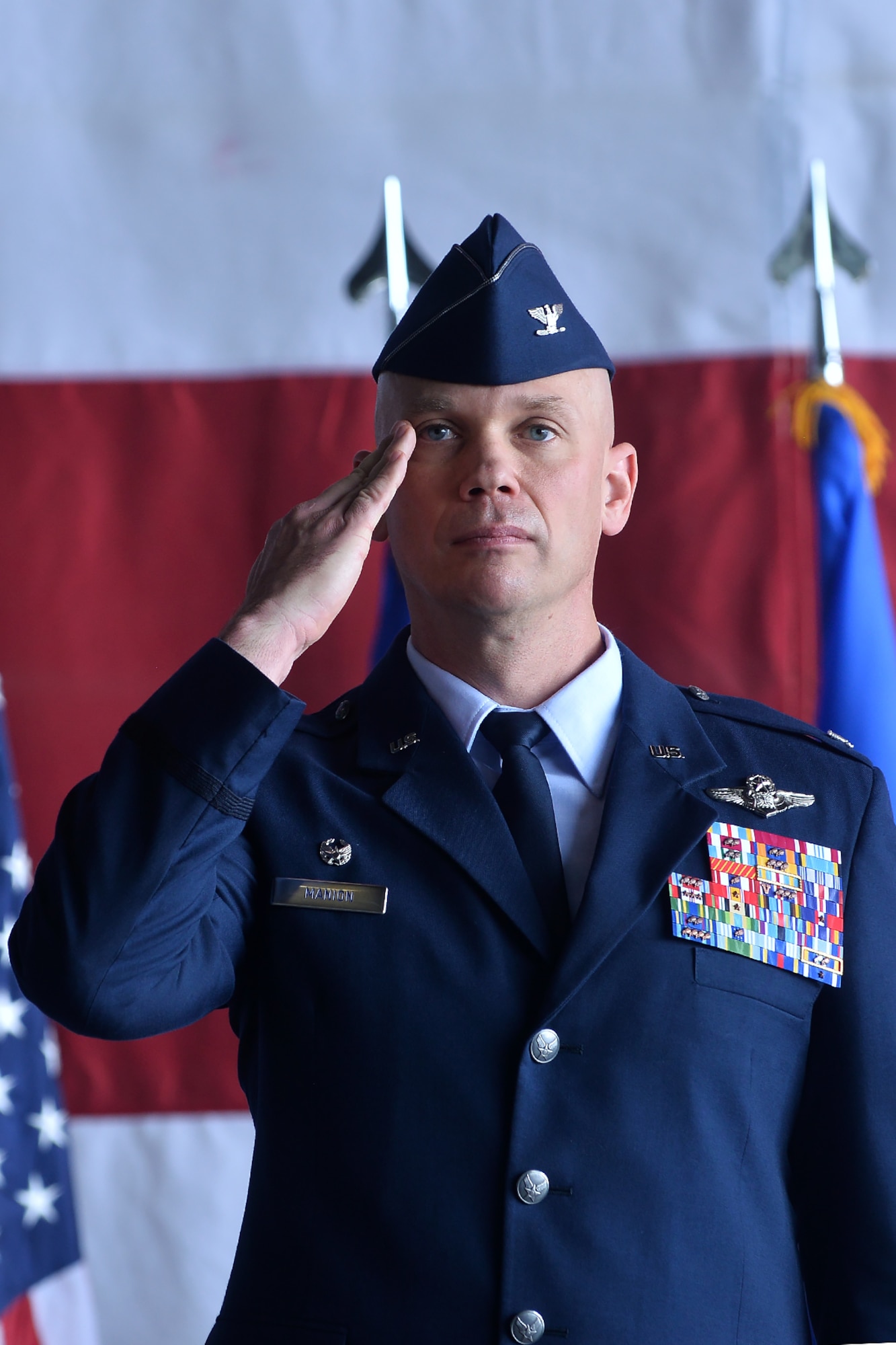 Col. Michael Manion renders his first salute as the 55th Wing commander during the 55th Wing change of command ceremony in Dock 1 of the Bennie Davis Maintenance Facility on Offutt Air Force Base, Neb., June 8. The Fightin' Fifty-Fifth said farewell to Col. Marty Reynolds and welcomed Col. Manion.