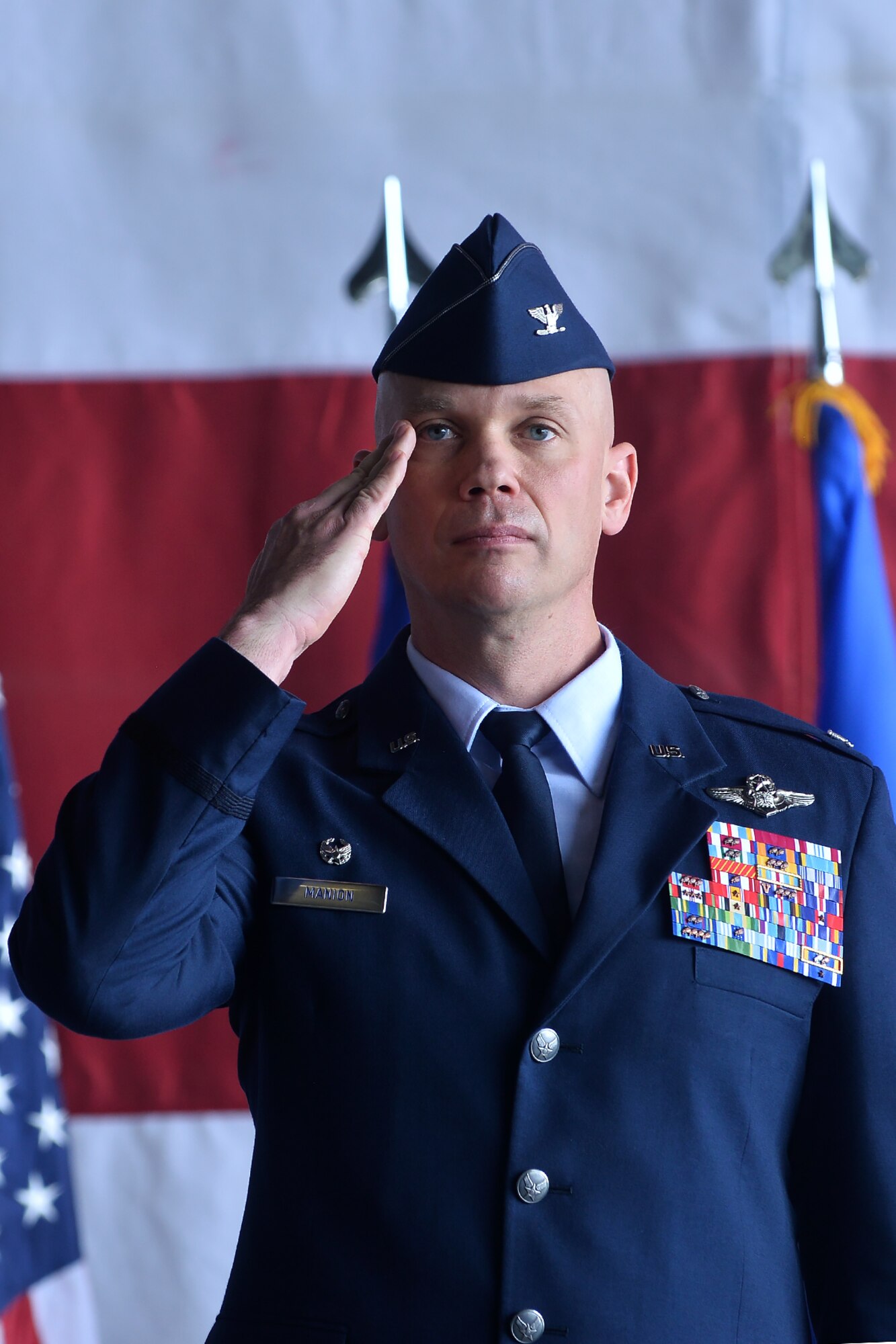 Col. Michael Manion renders his first salute as the 55th Wing commander during the 55th Wing change of command ceremony in Dock 1 of the Bennie Davis Maintenance Facility on Offutt Air Force Base, Neb., June 8. The Fightin' Fifty-Fifth said farewell to Col. Marty Reynolds and welcomed Col. Manion.