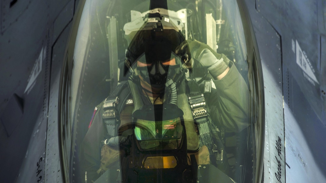 An Air Force pilot signals to a boom operator while receiving fuel from a KC-135R Stratotanker during the Baltic Operations exercise over Latvia, June 7, 2017. The exercise aims to strengthen combined response capabilities and demonstrate resolve among allied and partner nations' forces to ensure stability in, and if necessary defend, the Baltic Sea region. Air Force photo by Staff Sgt. Jonathan Snyder