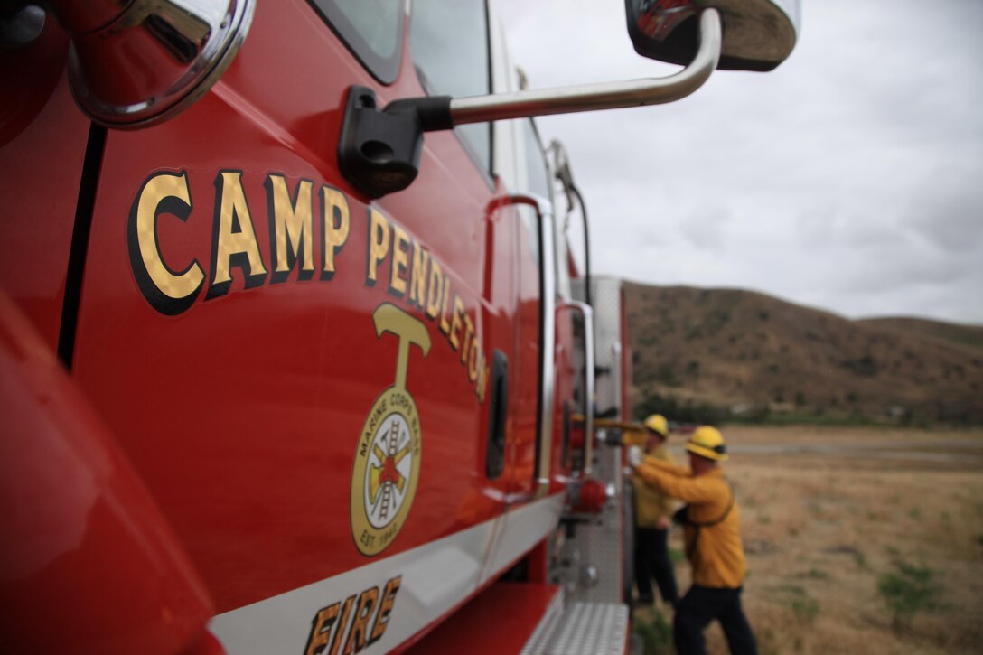 Firefighters from the Camp Pendleton Fire Department pack the firetruck up after participating in Wildland Fire Fighting Exercise 2016, near Pulgas Lake on Camp Pendleton, Calif., May 5, 2016. Wildland Firefighting Exercise 2016 is part of an annual training exercise to simulate the firefighting efforts by aviation and ground assets from the Navy, Marine Corps, San Diego County and CAL Fire.  This event is aimed at bringing awareness to this joint capability while also exercising the pilots and operators who conduct firefighting missions.(U.S. Marine Corps photo by Cpl. Brian Bekkala/MCIWEST-MCB CamPen Combat Camera/Released)