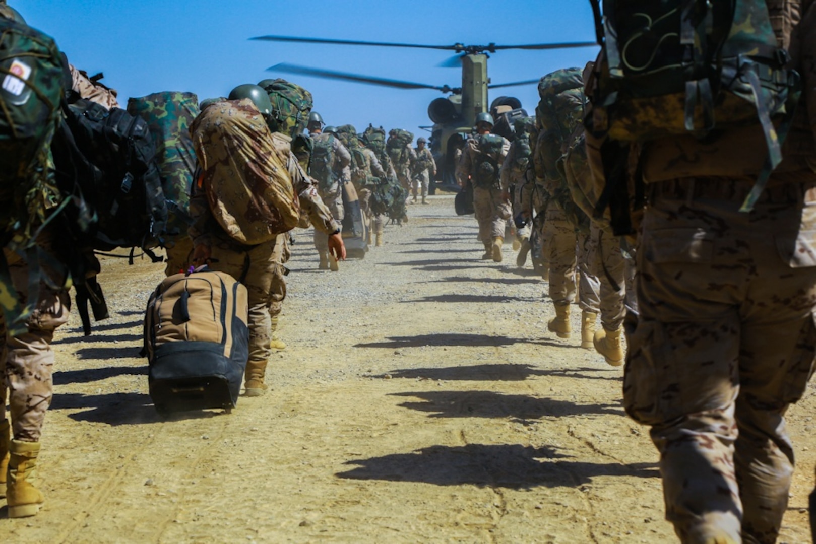 Spanish trainers load a CH-47 Chinook helicopter after spending six months in Iraq at the Besmaya Range Complex, training Iraqi security forces in support of Combined Joint Task Force Operation Inherent Resolve, May 9, 2017. Training at building partner capacity sites is an integral part of the effort to train Iraqi security forces personnel to defeat the Islamic State of Iraq and Shyria. CJTF-OIR is the global coalition to defeat ISIS in Iraq and Syria. Army photo by Spc. William Gibson