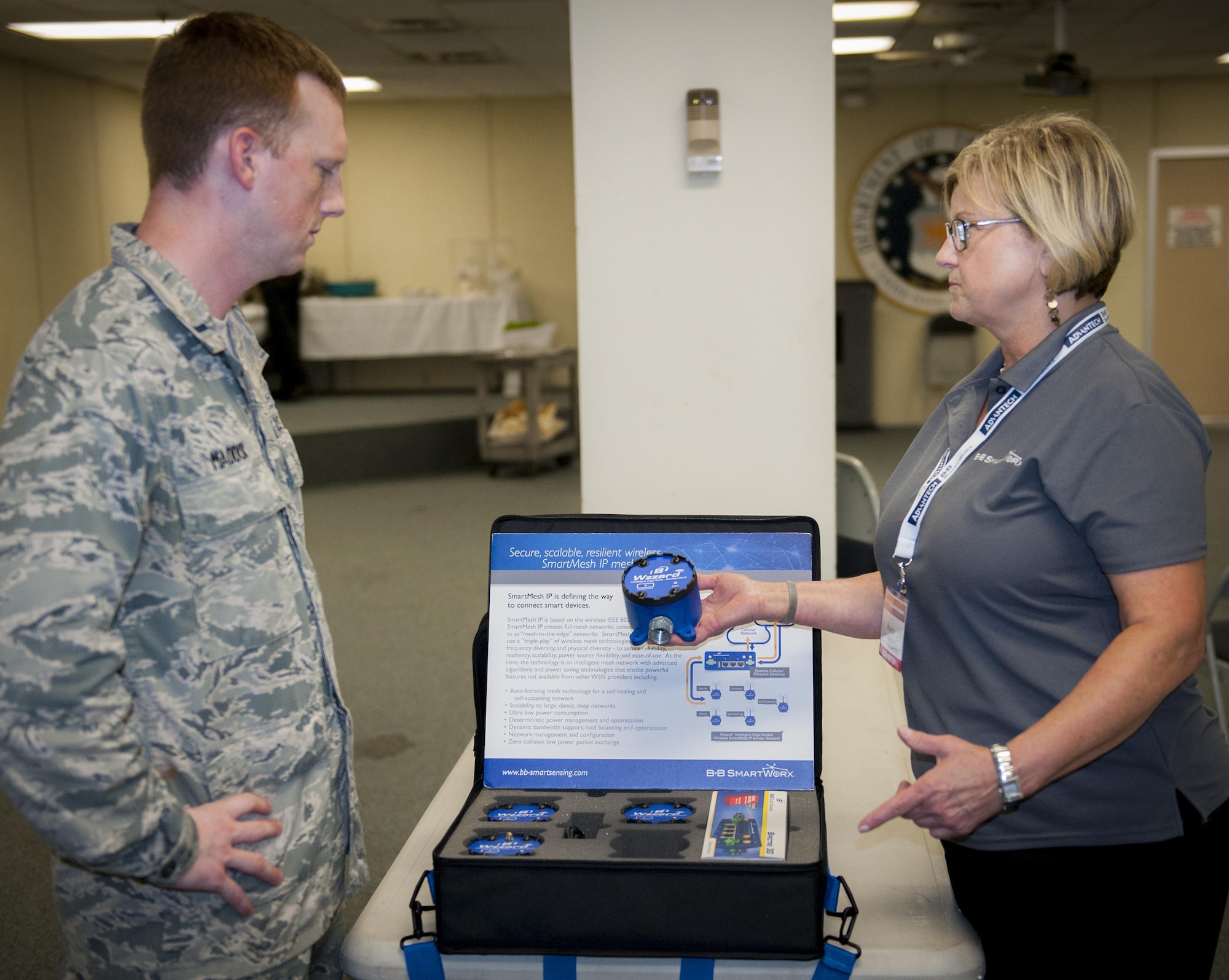 Robyn Waldorf, B&B SmartWorx, demonstrates a wireless mesh internet network sensing platform to 1st Lt. Michael Maddox, 96th Communications Squadron at the Technology Expo at Eglin Air Force Base, Fla. June 8.  More than 20 exhibitors from across the country offered information and displays about the latest defense technologies; storage solutions; and logistical and engineering services, among other technologies.  (U.S. Air Force photo/Kevin Gaddie)    