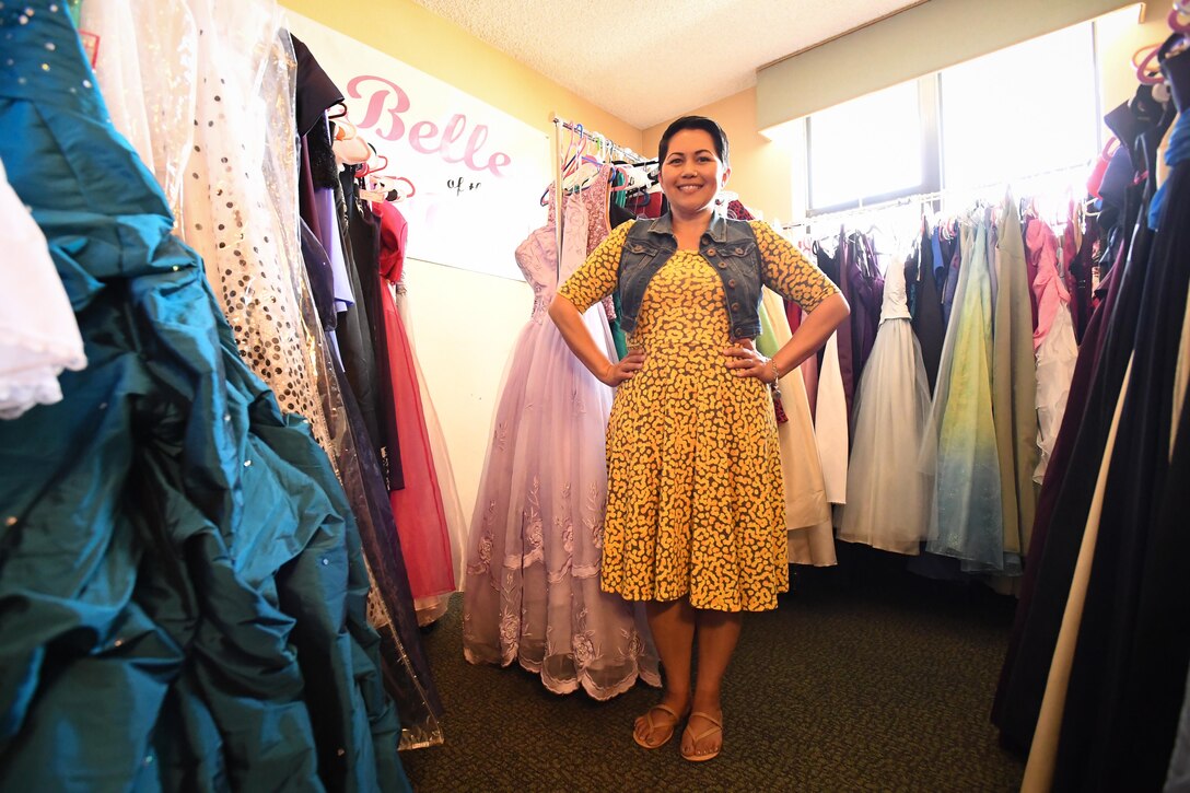 Angy Hogan poses with dresses at Hill Air Force Base, June 8. Hogan coordinates the ‘Belle of the Ball’ loan closet, a program that provides, free of charge, formal and semi-formal wear to active duty, retirees and their dependents so that they may have something beautiful to wear for special occasions. She is the spouse of active duty Tech. Sgt. Thomas Hogan, Air Force Nuclear Weapons Center, and was recently named 2017 Armed Forces Insurance Military Spouse of the Year for Hill AFB.  (U.S. Air Force/R. Nial Bradshaw)