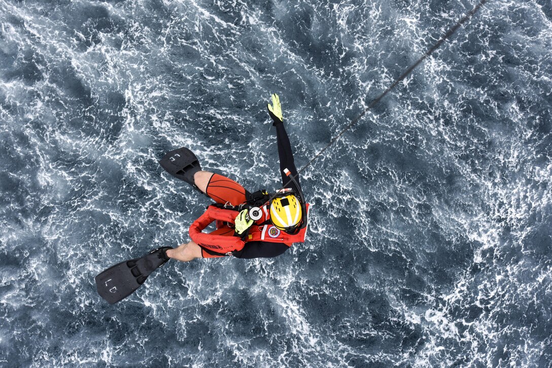 Coast Guard Petty Officer 2nd Class Lyman Dickinson descends from an MH-60 Jayhawk helicopter during a joint search and rescue exercise with the Mexican navy off the coast of Ensenada, Mexico, June 7, 2017. Dickinson is an aviation survival technician based at Coast Guard Sector San Diego. Coast Guard photo by Petty Officer 3rd Class Joel Guzman