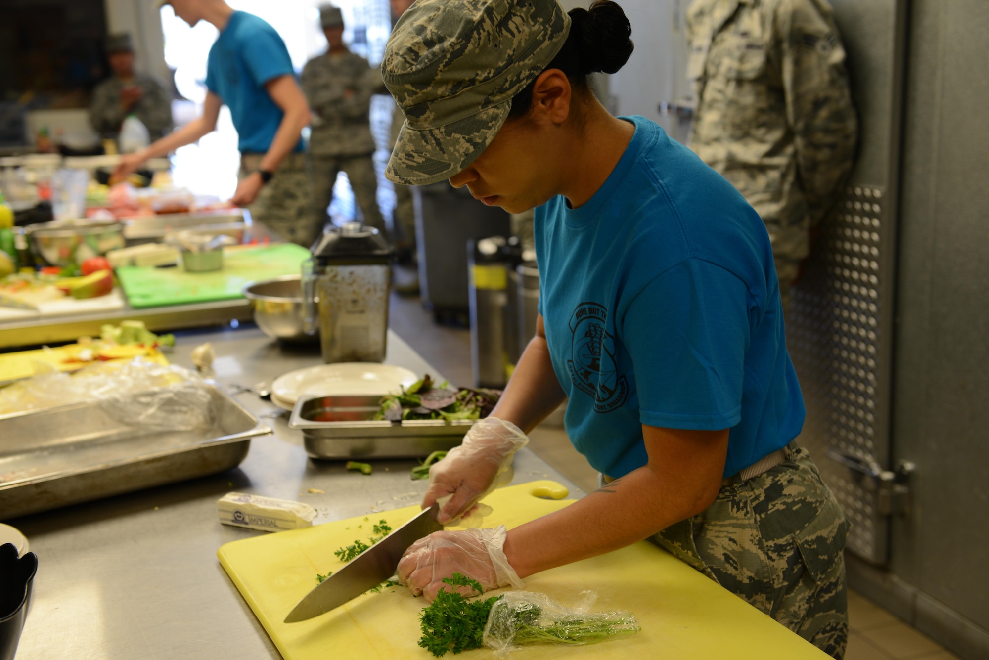 Staff Sgt. Amber Sansone, 341st Force Support Squadron missile chef, cuts parsley during the Warrior Chef competition June 7, 2017 at Malmstrom Air Force Base, Mont. Sansone and Airman 1st Class Nicki Agunos, 341st FSS missile chef, worked on the same team and won the competition. (U.S. Air Force photo/Staff Sgt. Delia Marchick)