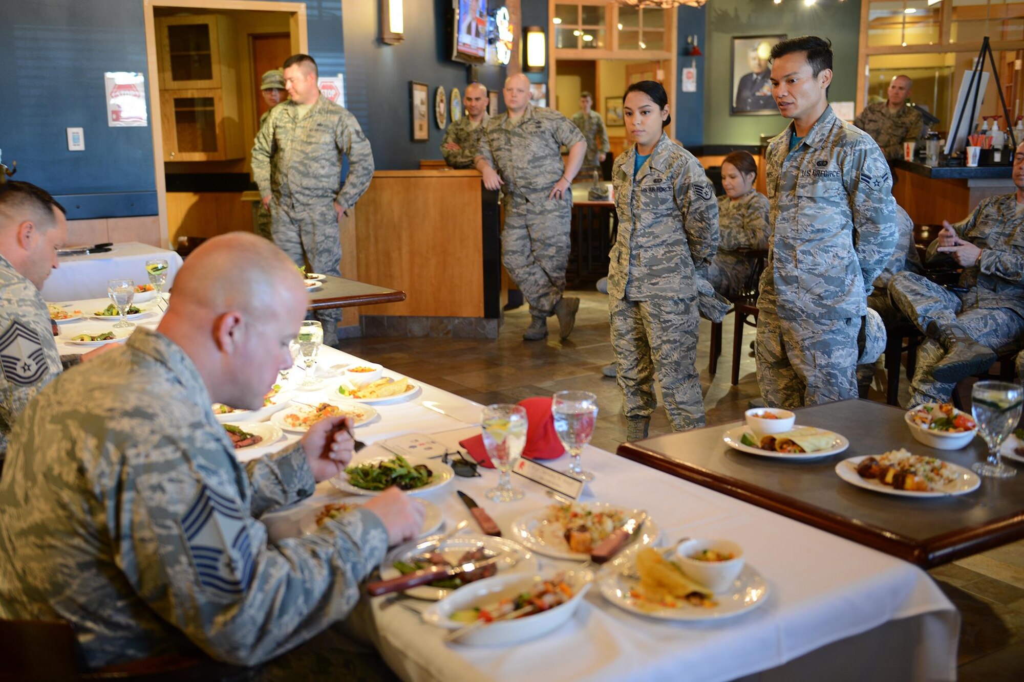 Staff Sgt. Amber Sansone and Airman 1st Class Nicki Agunos, both 341st Force Support Squadron missile chefs, wait as the judges sample the dishes they prepared for the Warrior Chef competition June 7, 2017 at Malmstrom Air Force Base, Mont. Sansone and Agunos won the competition with a meal of steak with mango sauce, shrimp and vegetables with honey almond sauce, garlic mashed potatoes and mango salad. (U.S. Air Force photo/Staff Sgt. Delia Marchick)