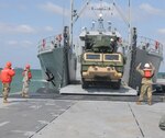 U.S. Soldiers and Marines wait on the Trident Pier in Pohang, South Korea, to offload tactical vehicles from a U.S. Army Landing Craft Utility 2020 ship during Operation Pacific Reach 2017, April 10. Service members from the Army, Navy and Marines came together to participate in the combined joint exercise that tested Logistics Over-the-Shore, inland waterway and Air Terminal Supply Point capabilities.