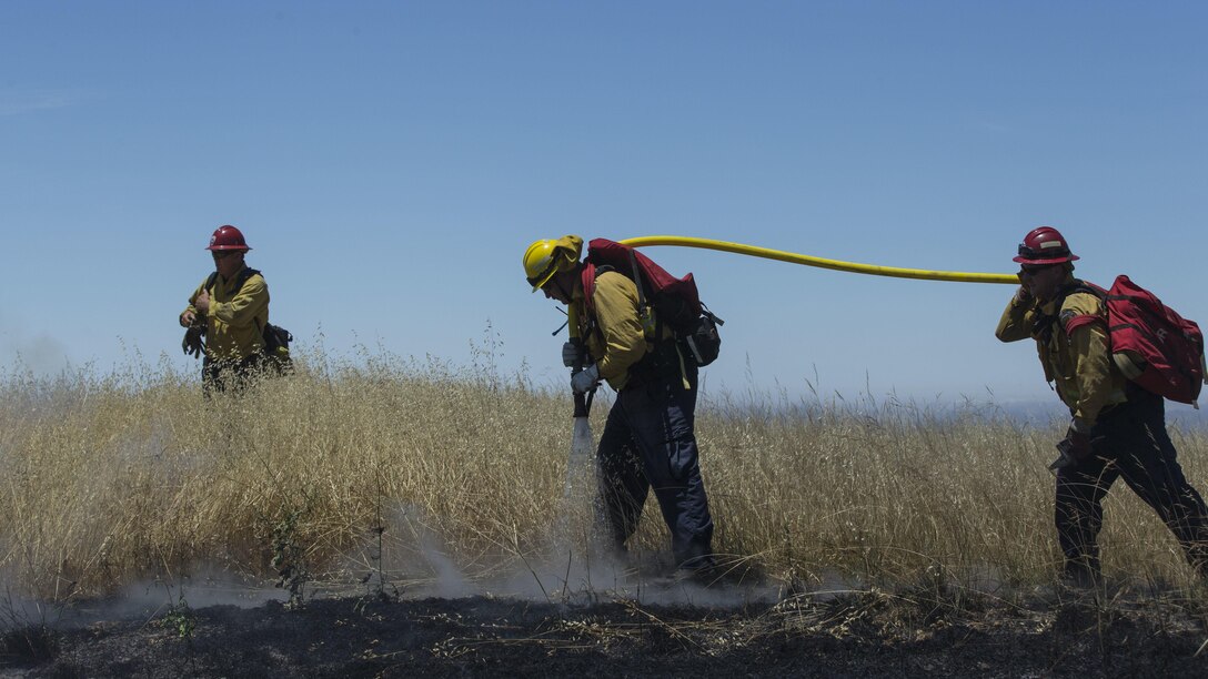 Over 200 firefighters with the U.S. Forest Service, Orange County Fire Authority, Cal Fire, and local San Diego County agencies gathered on Camp Pendleton, Calif. to participate in wildfire firefighting methods training, June 5, 2017. This training is conducted to further enhance their abilities to effectively and efficiently combat wildfires. Significant wildland fires throughout San Diego County in October of 2007 lead officials to seek a partnership between military and civilian aviation and firefighting assets to better manage crisis aboard regional military installations and in the surrounding communities. Since then, Camp Pendleton security and safety agencies, and local departments have been working together to streamline response and integrated communication efforts to provide ready, trained and certified military and civilian resources to combat wildland fires in the region, culminating with a cooperative effort to extinguish wildland fires.  (U.S. Marine Corps photo by Lance Cpl. Michael LaFontaine)