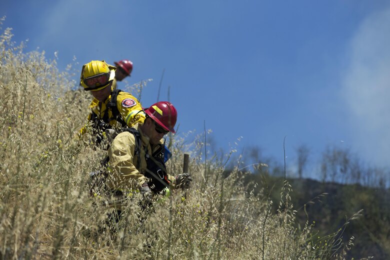 Over 200 firefighters with the U.S. Forest Service, Orange County Fire Authority, Cal Fire, and local San Diego County agencies gathered on Camp Pendleton, Calif. To participate in wildfire firefighting methods training, June 5, 2017. This training is conducted to further enhance their abilities to effectively and efficiently combat wildfires. Significant wildland fires throughout San Diego County in October of 2007 lead officials to seek a partnership between military and civilian aviation and firefighting assets to better manage crisis aboard regional military installations and in the surrounding communities. Since then, Camp Pendleton security and safety agencies, and local departments have been working together to streamline response and integrated communication efforts to provide ready, trained and certified military and civilian resources to combat wildland fires in the region, culminating with a cooperative effort to extinguish wildland fires.  (U.S. Marine Corps photo by Lance Cpl. Michael LaFontaine)