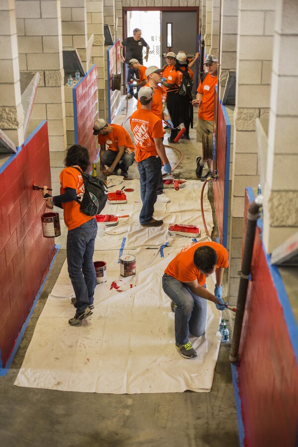 Volunteers with The Home Depot’s Building Materials department and their vendor partners paint the kennels during the K9 upgrade project aboard Camp Pendleton, Calif, June 7, 2017. Volunteers painted and repaired kennels as well as constructed a new shade structure and obstacle courses to increase the quality of training.