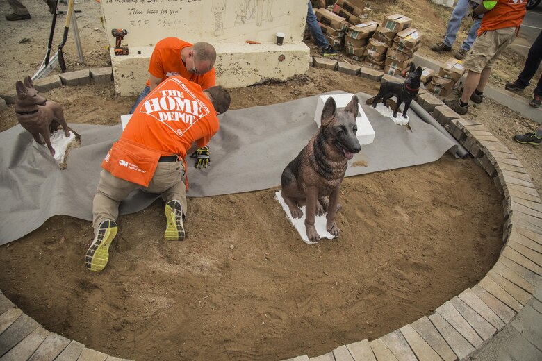 Volunteers with The Home Depot’s Building Materials department and their vendor partners restore the memorial of Sergeant Adam Cann during the K9 upgrade project aboard Camp Pendleton, Calif, June 7, 2017. Volunteers painted and repaired kennels as well as constructed a new shade structure and obstacle courses to increase the quality of training.