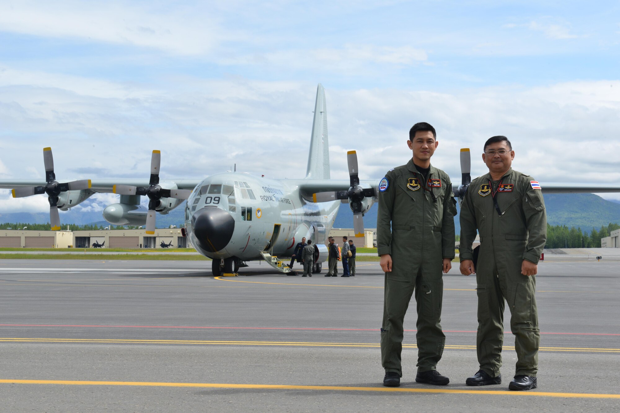 Two Royal Thai Air Force Airmen stand in front of their C-130 Hercules on the Joint Base Elmendorf-Richardson Flightline June 8 during Operation Red Flag-Alaska 17-_. RF-A is a Pacific Air Forces-directed field training exercise for U.S. and international forces flown under simulated air combat conditions. It is conducted on the Joint Pacific Alaska Range Complex with air operations flown primarily out of Eielson Air Force Base and JBER.