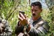 U.S. Air Force 1st Lt. Manuel Lamson, 9th Expeditionary Bomb Squadron weapon systems officer, applies camouflage face paint during a combat search and rescue training exercise June 5, 2017, at Andersen South, Guam. During the exercise, Lamson acted as a downed aircrew member, along with three other Airmen, and was tested on his ability to survive and evade in a jungle environment. (U.S. Air Force photo by Staff Sgt. Joshua Smoot)

