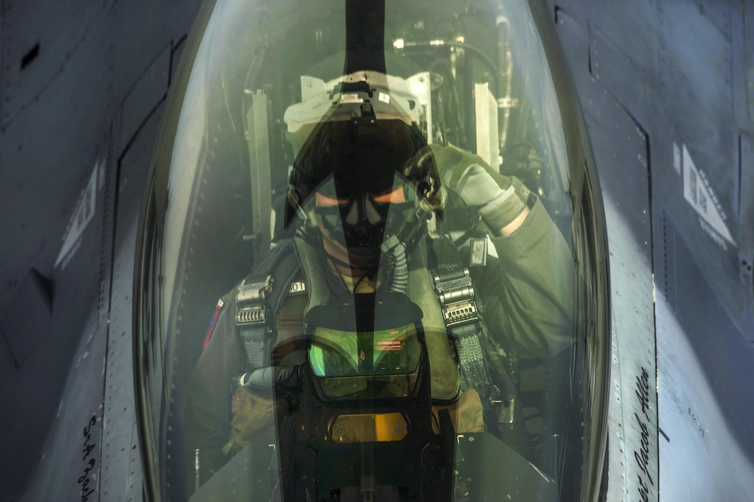 An Air Force pilot signals to a boom operator while receiving fuel from a KC-135R Stratotanker during the Baltic Operations exercise over Latvia, June 7, 2017. The exercise aims to strengthen combined response capabilities and demonstrate resolve among allied and partner nations' forces to ensure stability in, and if necessary defend, the Baltic Sea region. Air Force photo by Staff Sgt. Jonathan Snyder