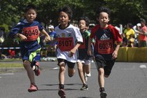 Children run the home stretch of the 2K Kids Run during the 33rd Annual Yokota Striders Ekiden at Yokota Air Base, Japan, June 4, 2017. The races, which consisted of a 2K Kids Run, 2K Family Run, 5K Race and the main Ekiden Race event, promoted friendship and physical fitness. (U.S. Air Force photo by Machiko Arita)
