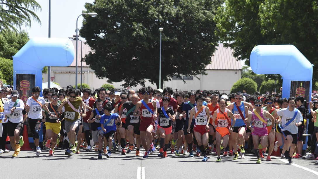 Competitors start running the main event, the Ekiden at Yokota Air Base, Japan, June 4, 2017. An Ekiden is a Japanese long distance relay that consists of teams of runners covering a certain distance. The Yokota Ekiden is 20K in distance made up of four runners each running a 5K. (U.S. Air Force photo by Machiko Arita)