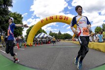 Participants in the Ekiden Race cross the finish line at Yokota Air Base, Japan, June 4, 2017. More than 5,000 runners participated in the event hosted by the Yokota Striders Running Club. (U.S. Air Force photo by Machiko Arita)