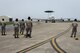 U.S. Air Force crew chiefs and specialists from the 961st Aircraft Maintenance Unit prepare to recover an approaching E-3 Sentry from the 961st Airborne Air Control Squadron June 8, 2017, at Kadena Air Base, Japan. To prepare the aircraft to fly, AMU Airmen perform day-to-day maintenance, specializing in a wide variety of systems such as radio, navigation, radar, coolant and computer systems. (U.S. Air Force photo by Senior Airman John Linzmeier)