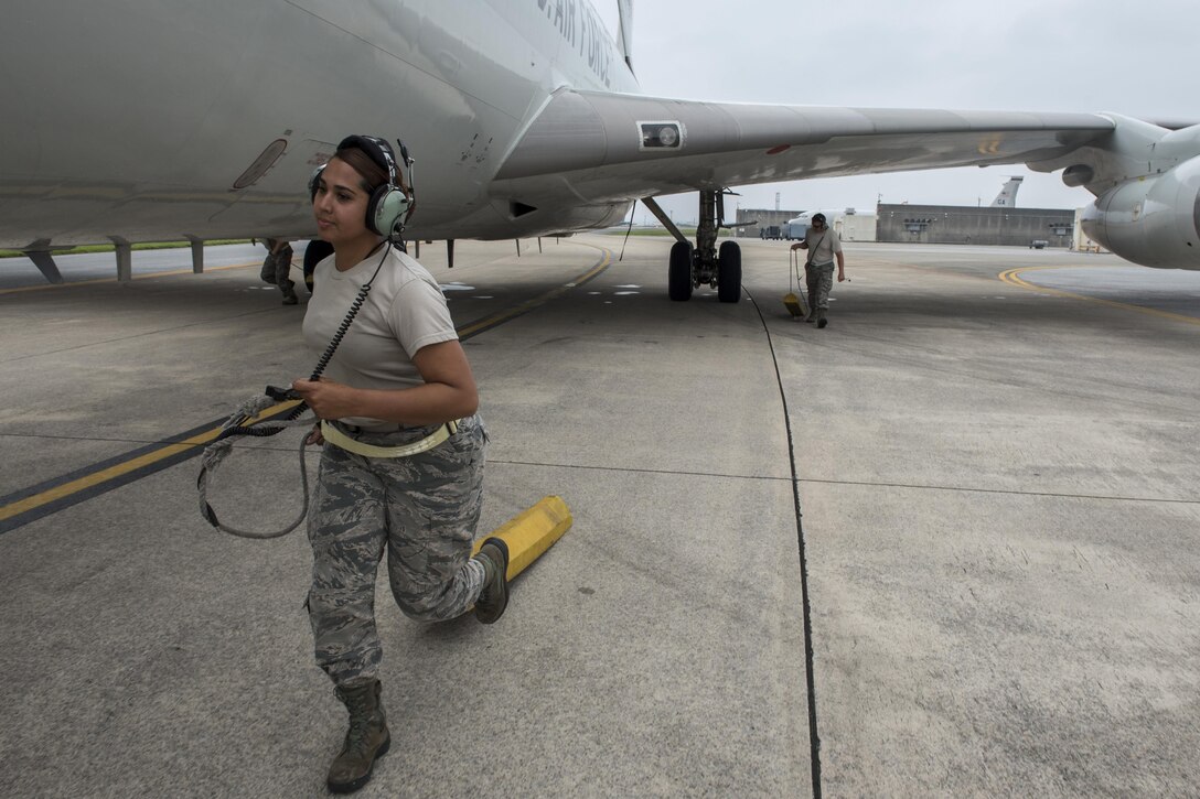 U.S. Air Force Airman 1st Class Erika Jimenez, 961st Aircraft Maintenance Unit aerospace propulsion technician, pulls away an aircraft wheel chock from an E-3 Sentry from the 961st Airborne Air Control Squadron June 8, 2017, at Kadena Air Base, Japan. In support of air-to-ground operations, the Sentry can provide direct information needed for interdiction, reconnaissance, airlift and close-air support for friendly ground forces. (U.S. Air Force photo by Senior Airman John Linzmeier)