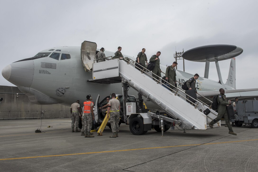 Aircrew from the 961st Airborne Air Control Squadron step off an E-3 Sentry June, 8, 2017, at Kadena Air Base, Japan. The 961st conducts routine training with local fighter units to stay proficient at air combat operations. (U.S. Air Force photo by Senior Airman John Linzmeier)