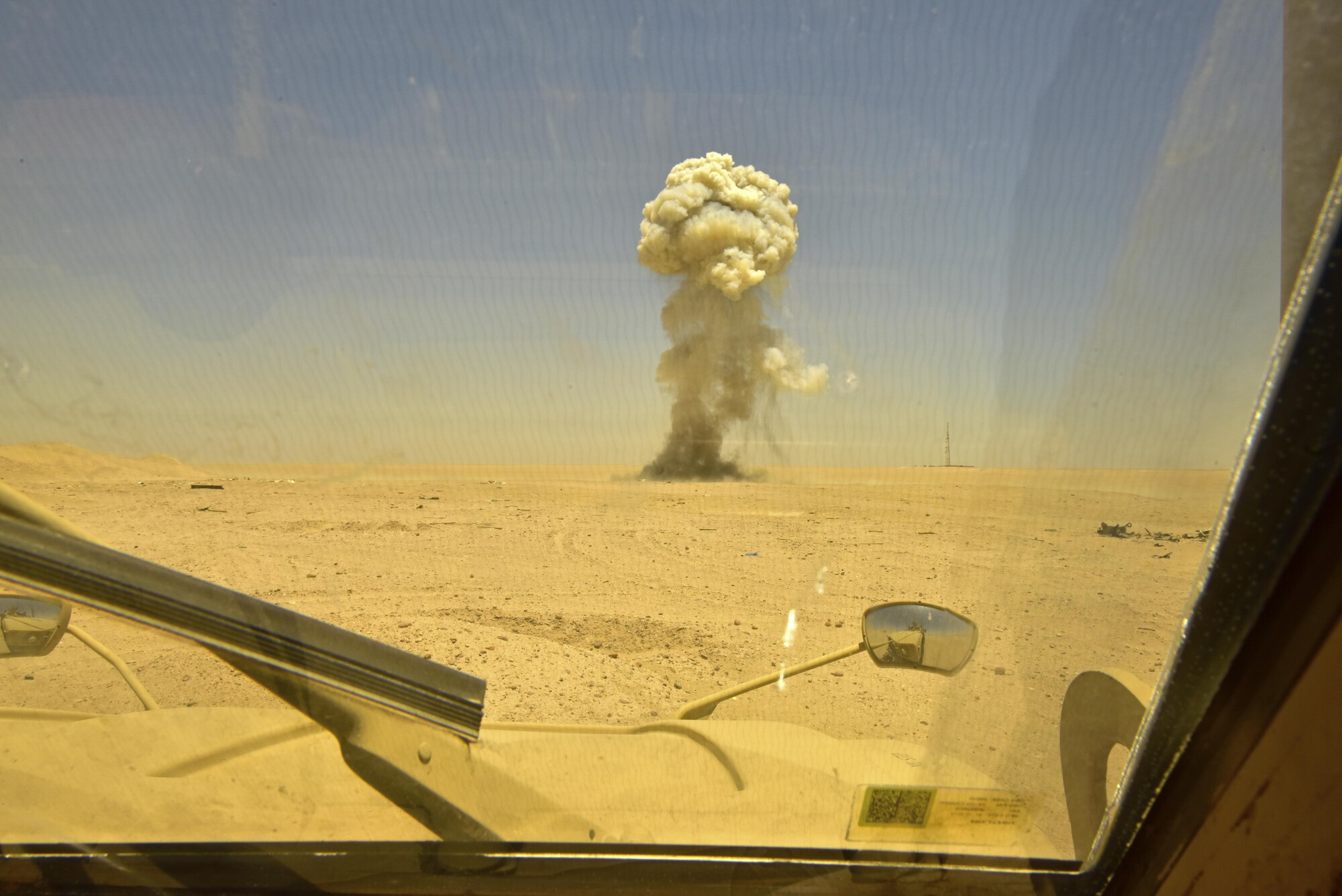 A controlled detonation blasts during a disposal operation in Southwest Asia, June 6, 2017. Personnel from the 407th Expeditionary Civil Engineer Squadron EOD, U.S. Marine Corps Special Marine Air Ground Task Force EOD and Italian Air Force completed the task of disposing of more than 5,000 pieces of expired 30 mm rounds and aircraft decoy flares. EOD’s mission is to protect personnel, resources, and the environment from hazardous explosive ordnance, improvised explosive devices and weapons of mass destruction, which may include; incendiary, chemical, biological, radiological, and nuclear hazards.  They specialize in tools, techniques and personal protective equipment to detect or identify, monitor, evaluate, interrogate, mitigate, render safe, recover, and disposal operations on ordnance or devices delivered, placed, or made dangerous by any circumstances. (U.S. Air Force photo by Senior Airman Ramon A. Adelan)