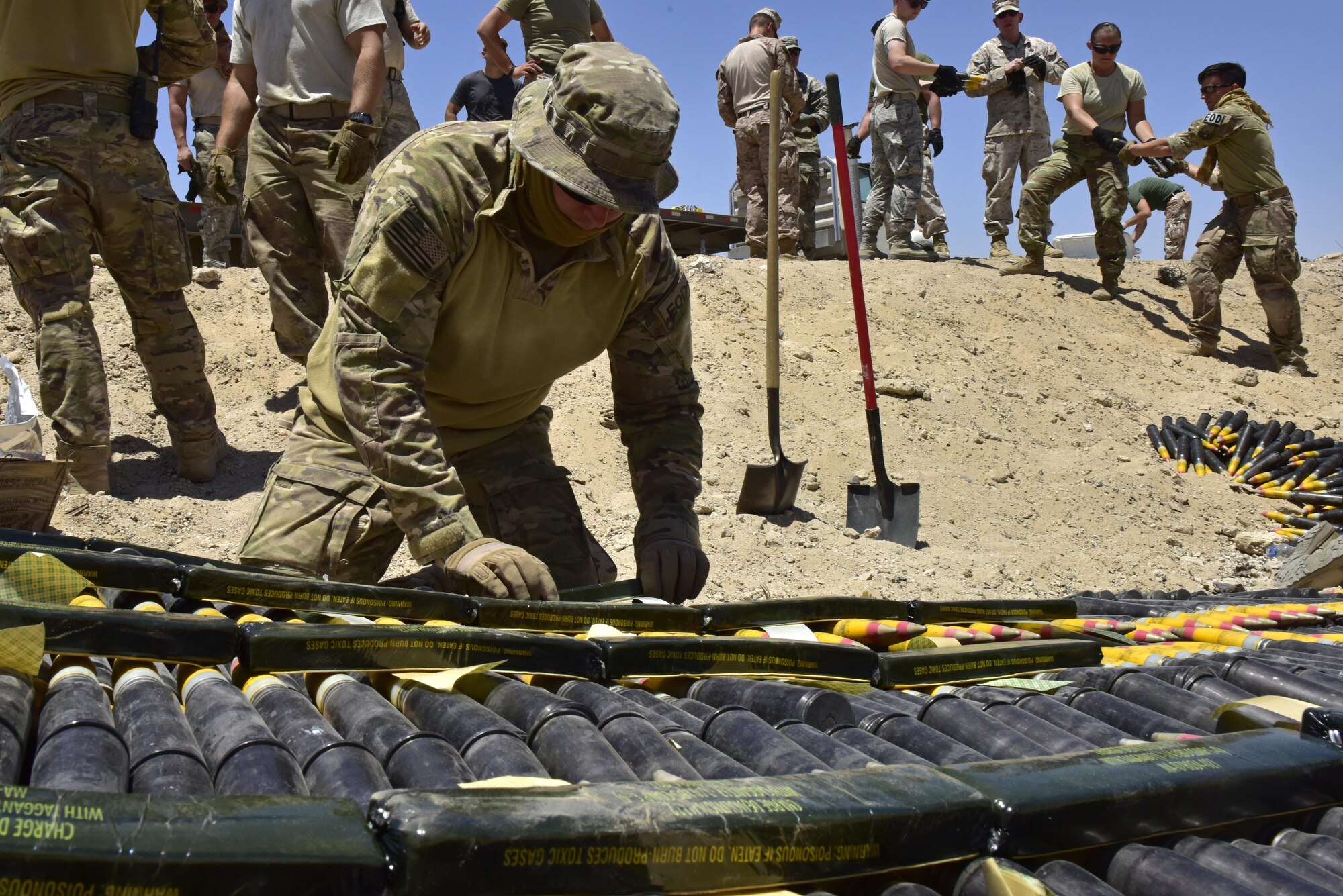 U.S. Air Force Staff Sgt. Devin Stuart, 407th Expeditionary Civil Engineer Squadron explosive ordnance disposal (EOD) technician, prepare explosives on munitions during a disposal operation in Southwest Asia, June 6, 2017. Personnel from the 407th Expeditionary Civil Engineer Squadron EOD, U.S. Marine Corps Special Marine Air Ground Task Force EOD, Italian Air Force completed the task of disposing of more than 5,000 pieces of expired 30 mm rounds and aircraft decoy flares. EOD’s mission is to protect personnel, resources, and the environment from hazardous explosive ordnance, improvised explosive devices and weapons of mass destruction, which may include; incendiary, chemical, biological, radiological, and nuclear hazards.  They specialize in tools, techniques and personal protective equipment to detect or identify, monitor, evaluate, interrogate, mitigate, render safe, recover, and disposal operations on ordnance or devices delivered, placed, or made dangerous by any circumstances. (U.S. Air Force photo by Senior Airman Ramon A. Adelan)