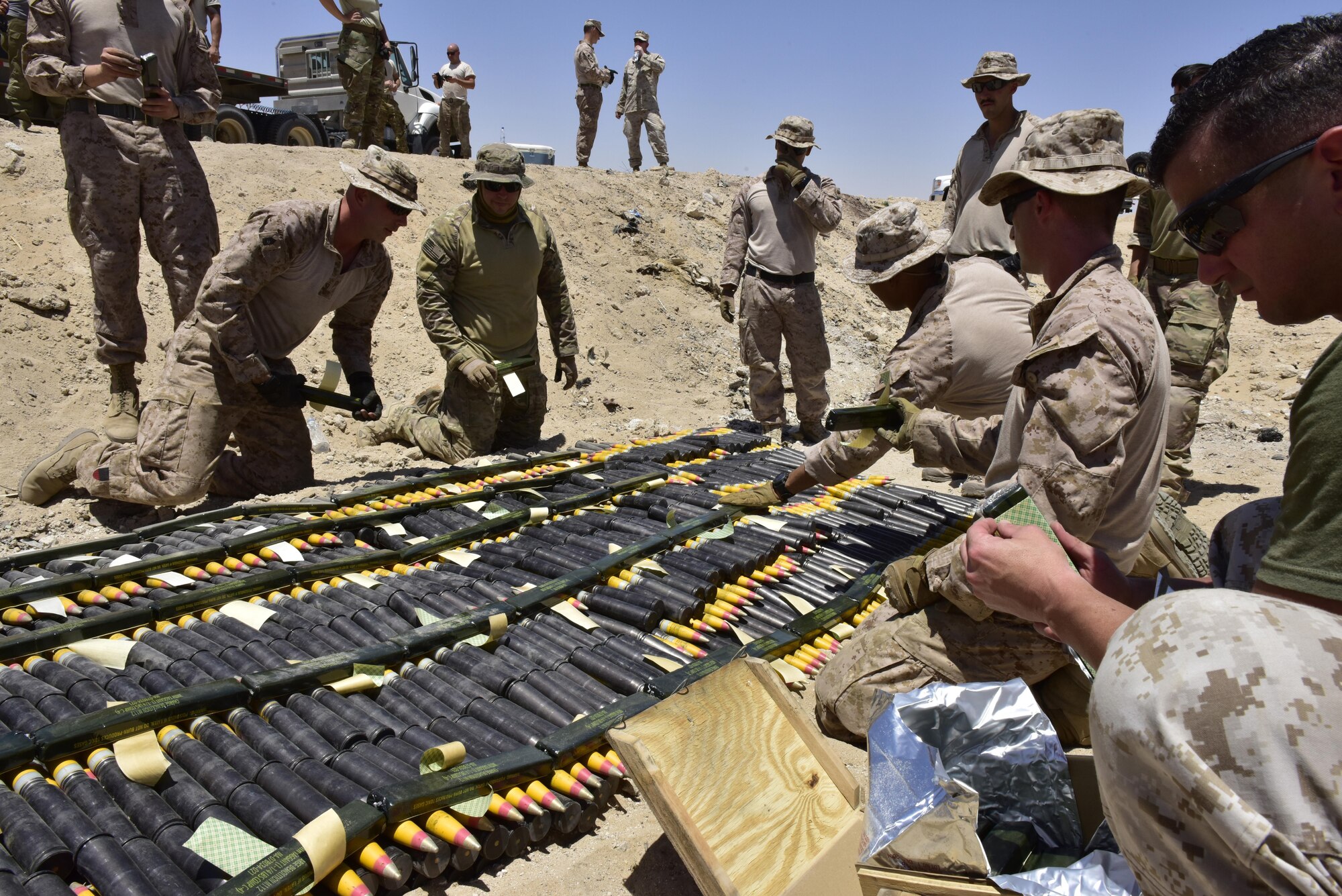 U.S. Air Force 407th Expeditionary Civil Engineer Squadron explosive ordnance disposal (EOD) and U.S. Marine Corps Special Marine Air Ground Task Force EOD prepare explosives on munitions during a disposal operation in Southwest Asia, June 6, 2017. Additional support from Italian Air Force and 407th Air Expeditionary Group assisted in completing the task of disposing of more than 5,000 pieces of expired 30 mm rounds and aircraft decoy flares. EOD’s mission is to protect personnel, resources, and the environment from hazardous explosive ordnance, improvised explosive devices and weapons of mass destruction, which may include; incendiary, chemical, biological, radiological, and nuclear hazards.  They specialize in tools, techniques and personal protective equipment to detect or identify, monitor, evaluate, interrogate, mitigate, render safe, recover, and disposal operations on ordnance or devices delivered, placed, or made dangerous by any circumstances. (U.S. Air Force photo by Senior Airman Ramon A. Adelan)