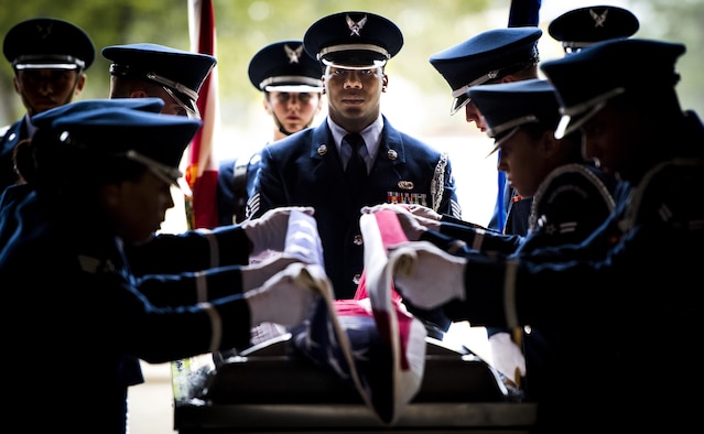 Staff Sgt. Gregory Barker, with the 96th Force Support Squadron, presides over the flag-folding portion of the Honor Guard graduation ceremony at Eglin Air Force Base, Fla., June 1, 2017. Approximately 12 new Airmen graduated from the course after more than 120 hours of training. The graduation performance, for friends, family and unit commanders, includes flag detail, rifle volley, pallbearers and bugler. (U.S. Air Force photo/Samuel King Jr.)