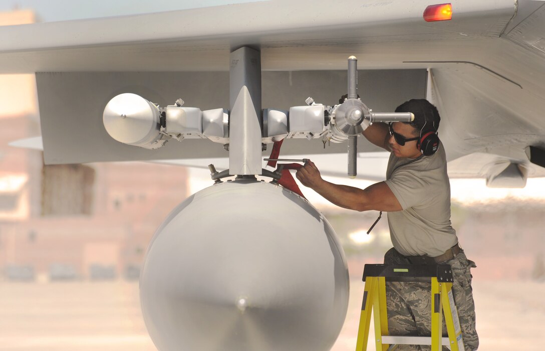 Senior Airman Nelson Chias-Ramos prepares an F-15 Strike Eagle for a morning sortie at Nellis Air Force Base, Nev., while performing final pre-flight checks and pulling final safety pins, June 2, 2017. (U.S. Air National Guard photo/ Master Sgt. John Hughel)