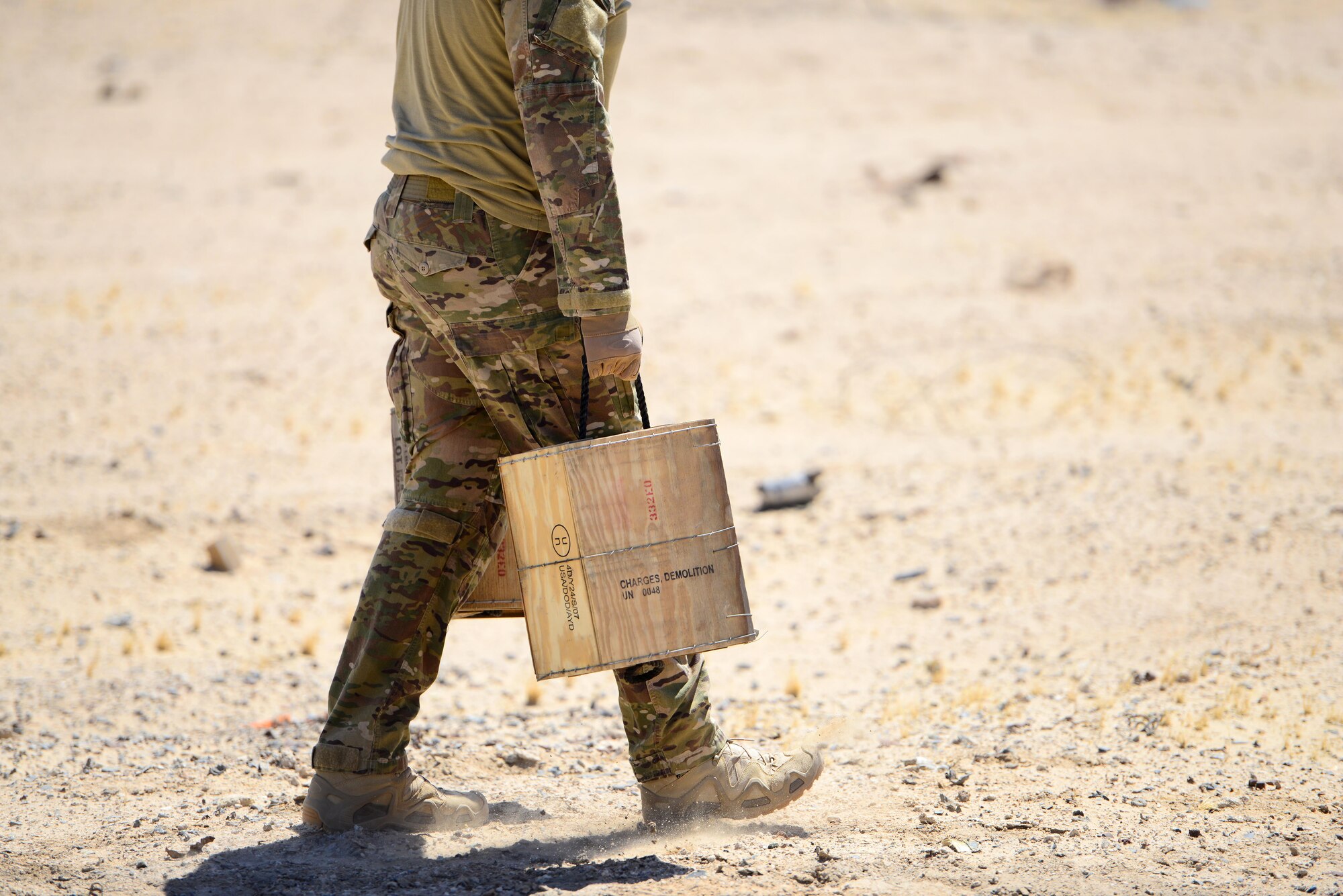 U.S. Air Force explosive ordnance disposal technicians assigned to the 407th Expeditionary Civil Engineer Squadron, carry C-4 explosives to the blast site at the range during a coordinated detonation in Southwest Asia on June 6, 2017. Explosive ordnance disposal technicians are charged with locating, identifying, disarming, neutralizing, recovering, and disposing of hazardous explosives; conventional, chemical, biological, incendiary, and nuclear ordnance; and criminal or terrorist devices.  (U.S. Air Force photo by Tech Sgt. Andy M. Kin)