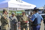 Alaska National Guard Sgt. Elijah Gutierrez, a civil operator with the Counterdrug Support Program, discusses the procedures for using the Narcan kit with Alaska State Trooper James Lester at the Edward G. Pitka Sr. Airport in Galena, Alaska, May 31, 2017. 