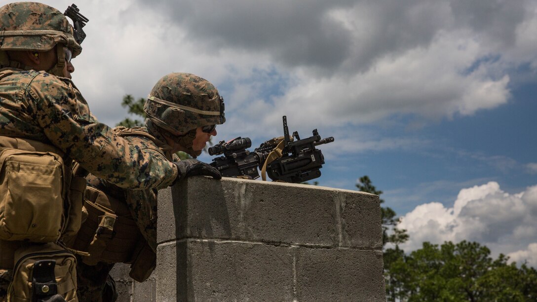 A Marine steadies an M320 grenade launcher module mounted on an M4 rifle on a wall before engaging simulated enemies at Camp Lejeune, N.C., June 6, 2017. 2nd Combat Engineer Battalion is one of the first Marine Corps units to test the M320, a more effective weapon system than the current M203 grenade launcher. 